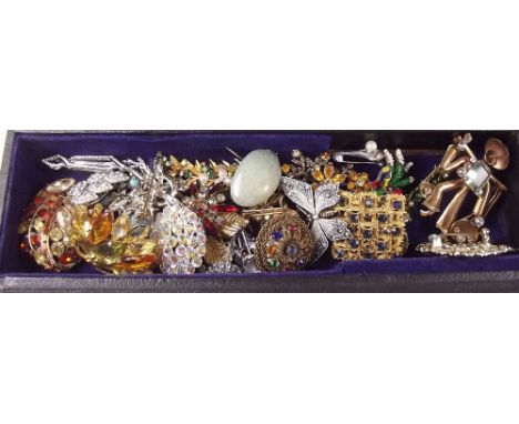 A box of vintage brooches