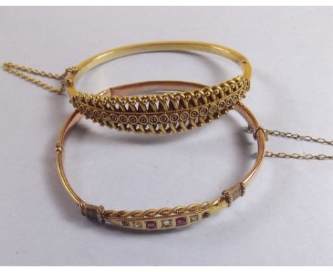 A Victorian hinged gold bangle (unmarked but tested 14ct) 12.5g and another gold bangle set rubies and diamonds (also unmarke