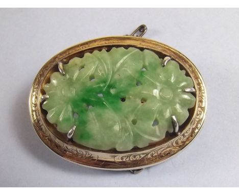 A silver framed floral carved jade brooch