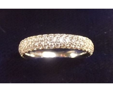 An 18 carat white gold eternity ring set triple row of diamonds, 3.7g, size M