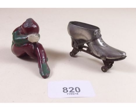 A miniature painted lead crouching figure of an elf 4cm and a Victorian novelty pin cushion in the form of a roller skate