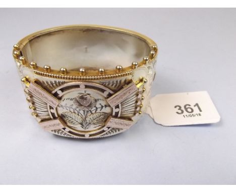A Victorian silver hinged bangle with engraved and applied decoration