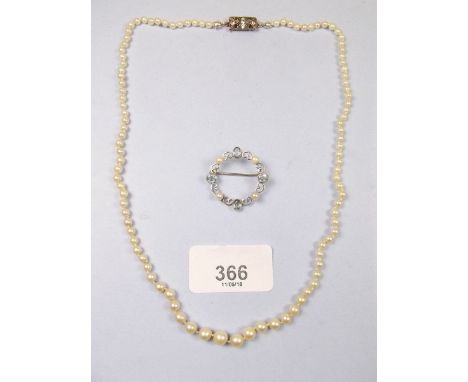 A silver pearl and aquamarine brooch and a pearl necklace with silver clasp