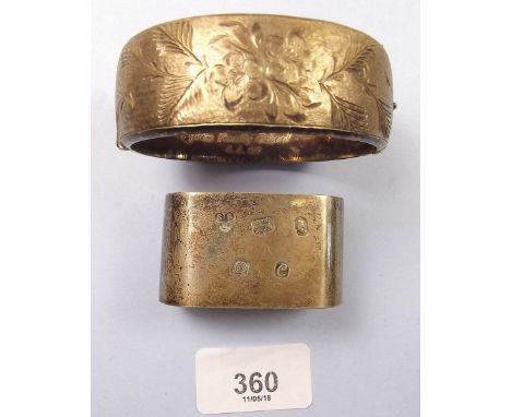 A silver napkin ring and a silver engraved bangle