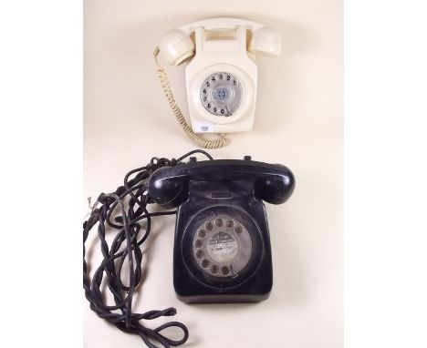 A cream vintage dial wall telephone and a black vintage telephone