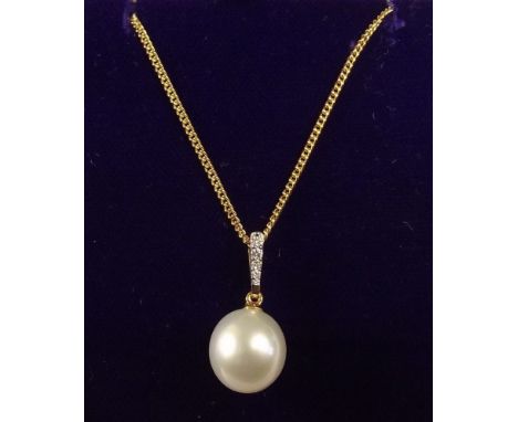 A large single pearl and diamond set pendant on 18 carat gold chain (pendant 3g and chain 5g)