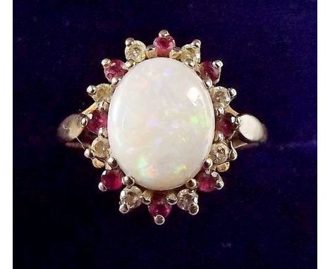 A 9 carat gold opal cluster ring with red and white stone surround