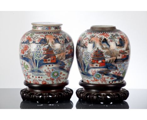 PAIR OF CHINESE GINGER JARS
with floral bird and architectural decoration, each 24cm high, one with lid lacking, each on wood