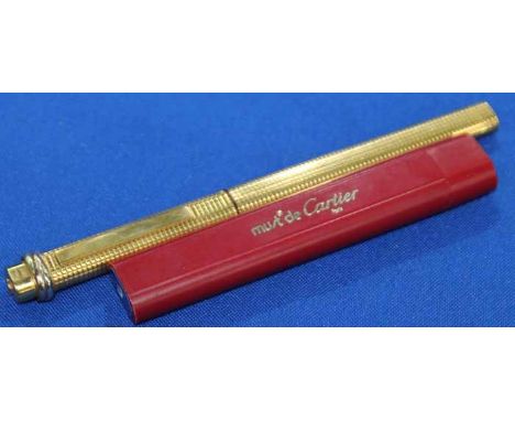 CARTIER GOLD PLATED BALL POINT PEN
with engine turned body and stamped with serial number; together with Must de Cartier pack