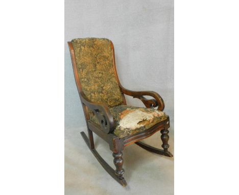 A Victorian mahogany framed rocking armchair in tapestry style upholstery. H.100 W.53 D.90cm 