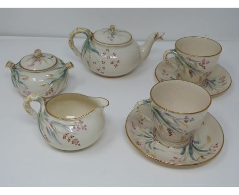 A 19th century Belleek Irish porcelain 1st period grasses pattern tea service. Hand painted with grasses and flowers and tass