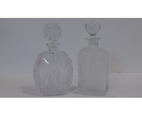 Two crystal decanters one very heavy lead crystal with a geometric and star cut design with matt and polished sections and ma