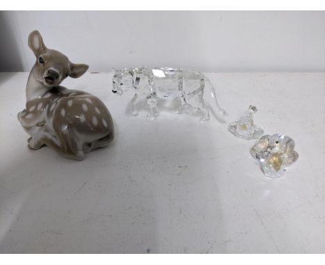 A Swarovski crystal sculpture of a lioness, along with two fantail doves, and a Royal Copenhagen model of a recumbent deer Lo