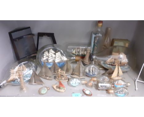 A quantity of model ships in glass bottles to include a Cutty Sark model together with silver plated Grenadier models of yach