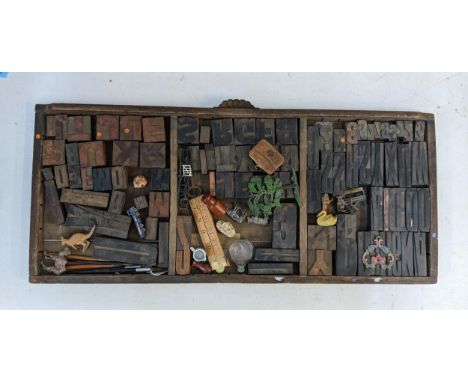A 19th/20th century printers tray containing a collection of printing blocks, metal model animals, related items and collecta