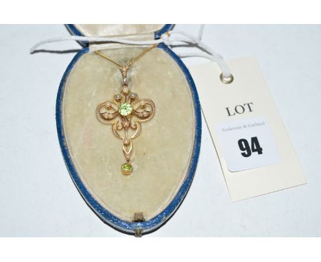 An Edwardian peridot and seed pearl drop pendant on chain, in fitted case.