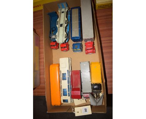 A collection of Dinky Supertoys trucks, including: a Foden flat bed eight-wheeler, with grey deck and red body work; a snow p