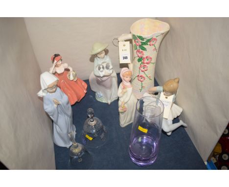 A Maling jug; two Nao figures; a Lladro ballerina; two other female figures; and two glass bells.