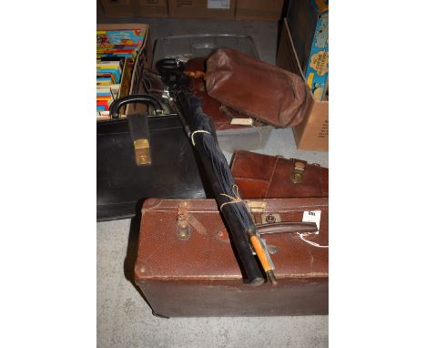 A leatherette case; a carved walking stick of elephants; an umbrella; a shooting stick; a vintage Gladstone bag; and three vi