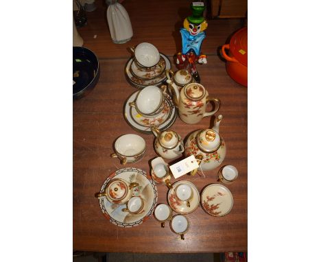 A Japanese eggshell tea and coffee service; and a multi coloured glass clown.