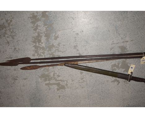 A First World War bayonet and scabbard; a pair of spears; and another spear.