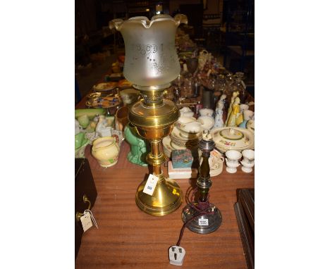 A brass table oil lamp with opaque shade; and an early 20th Century chromed table lamp.