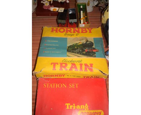A boxed Hornby 0-gauge clockwork train set, comprising: a small engine, three goods wagons, and a quantity of track, in origi