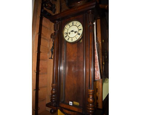 A Victorian Vienna wall clock in walnut case with enamel dial.