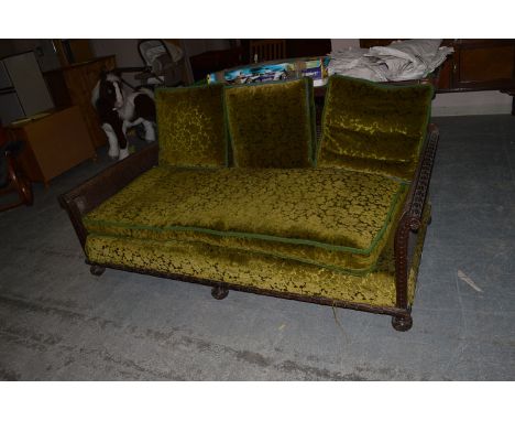 A late Victorian bergere sofa, with cane back and arms, the loose seat cushions upholstered in cut green dralon, 188cms wide.