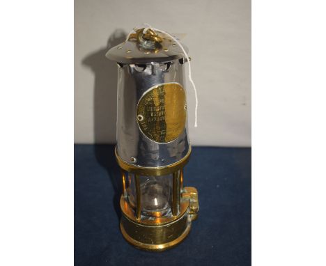 Protector Lamp & Lighting Company: a type GRS miner's lamp with polished steel bonnet above five brass bars, fuel canister fi