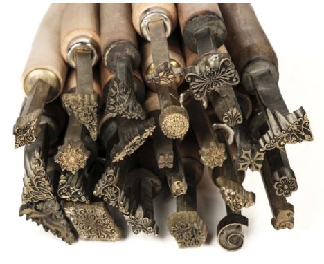 * Decorative finishing tools. 25 brass decorative finishing tools, comprising centre and corner tools (including three pairs 