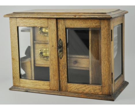 Victorian oak smoker's cabinet, glazed doors, flanked by glazed panels, fitted interior, together with a compass pipe, stampe