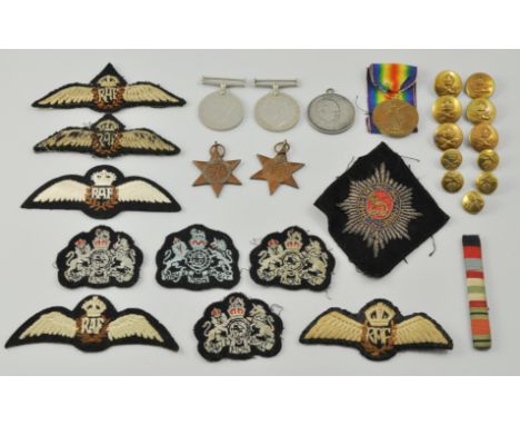 Militaria:  Collection of military badges, buttons, coins and medals, contained inside a small metal trunk.