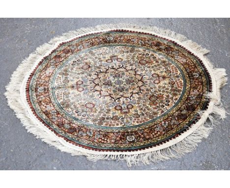 Tabriz silky pile circular rug, central medallion, floral surround, ivory coloured field, the border within guards, diameter 
