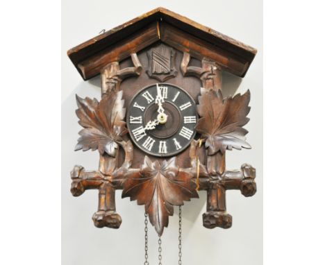 Black Forest style cuckoo clock, with a cuckoo and leaf pediment, 52cms.