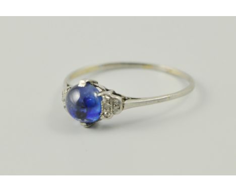 White metal cabochon sapphire and diamond ring, possible platinum.