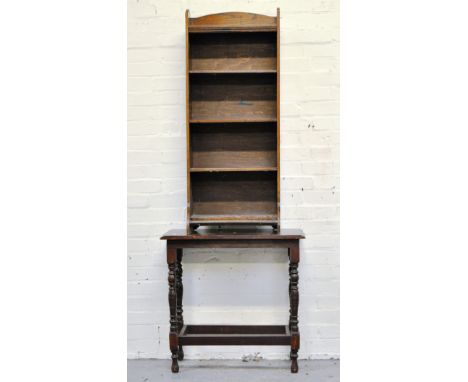 Oak open bookcase, stained wood table, two pine shelf units and an overmantel.