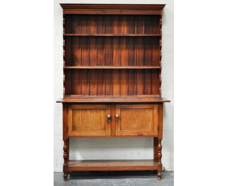 Teak wood dresser, two shelf delft rack, the base with two panelled doors over a pot board, width 138cm, height 120cm.