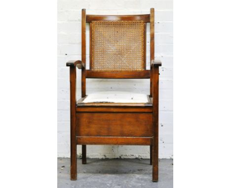 Stained beechwood stool commode, with a cane-panelled back, width 55cms.