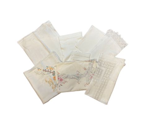 A good quantity of vintage and antique table linens to include a 1920s linen tray cloth and tea cosy with padded satin stitch