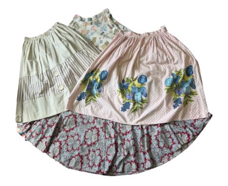 A collection of 8 vintage skirts, mostly 1950s, in various styles to include a pink gingham skirt with novelty fruit border p