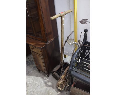 Two vintage garden implementsTo include a push Lion mower with grass box and a Spaldings London line marker (2) 