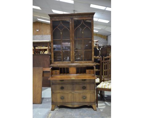 A good quality Regency style yew wood secretaire bookcase, 20th CenturyHaving a dentil cornice above two astragal glazed door