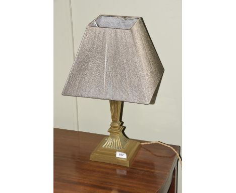 A Regency style gilt metal lamp baseThe stepped square section base extending to a reeded stem, adorned with a grey geometric
