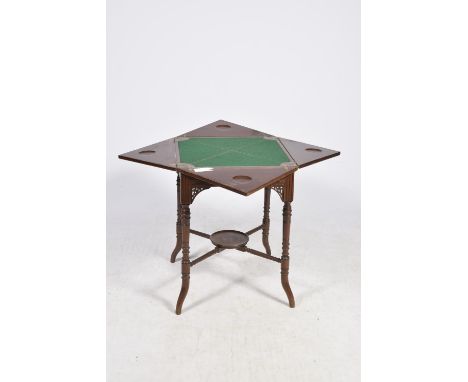 An Edwardian mahogany envelope card tableThe envelope folding top enclosing a baize lined playing surface above a single frie