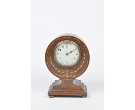 An Edwardian inlaid mahogany balloon mantle clockThe rounded section raised on a square plinth base the compressed gilt ball 