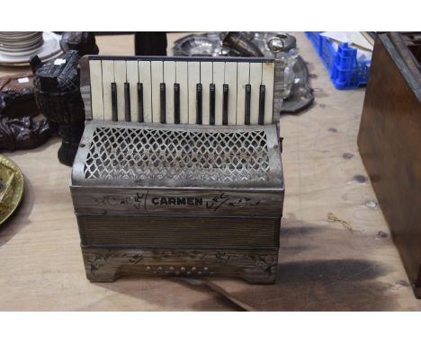 An early to mid 20th Century Carman piano accordionThe 25 key accordion with pearlescant  casing and cast metal pierced upper