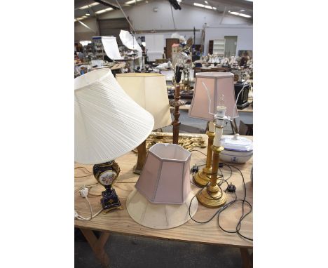 A pair of gilt Cornithian column table lampsEach with a circular plinth base, one with a fluted column lamp, a cobalt blue tw