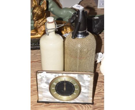 A small group of collectible itemsA 1930's soda siphon, a glass bottle and chrome fitting adorned with a chain mail exterior,