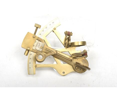 A brass sextent The removable instrument with various scales, lenses, and levers, unmarked, 12cm. 